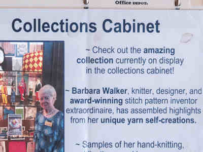 Barbara with exhibit in the cases near facility dining room